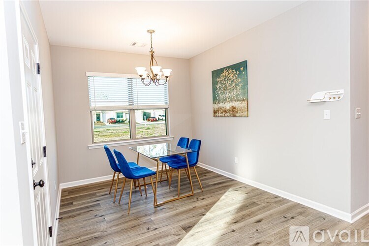 A dining room with a wooden table and blue chairs.