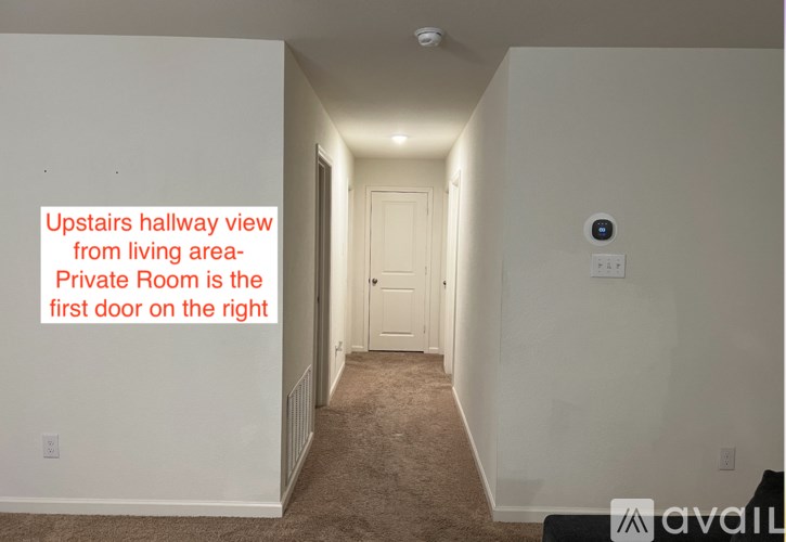A hallway leading to a private room with a camera on the wall.