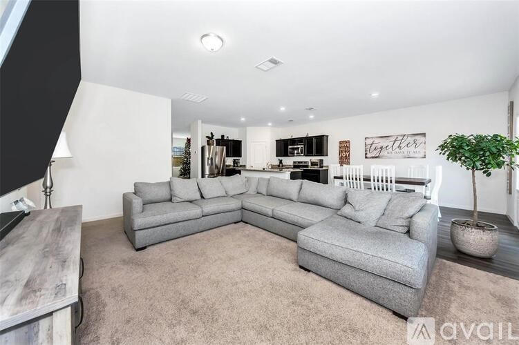 A living room with a grey sectional sofa and a coffee table.