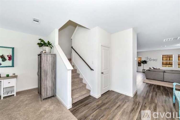 A living room with a staircase leading to the upper floor.