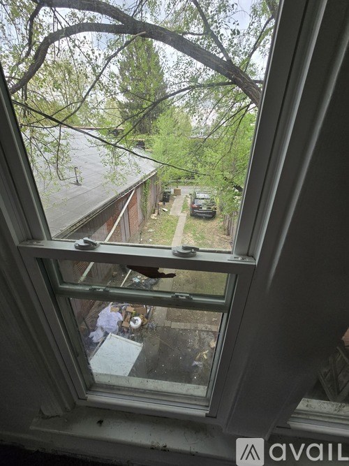A window with a view of a tree and a building.