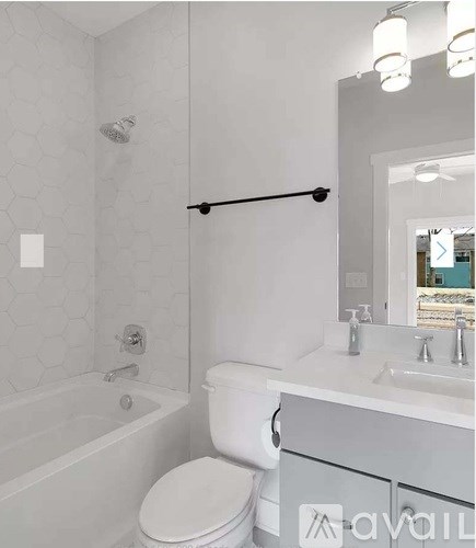 A white toilet sits next to a bathtub in a bathroom.