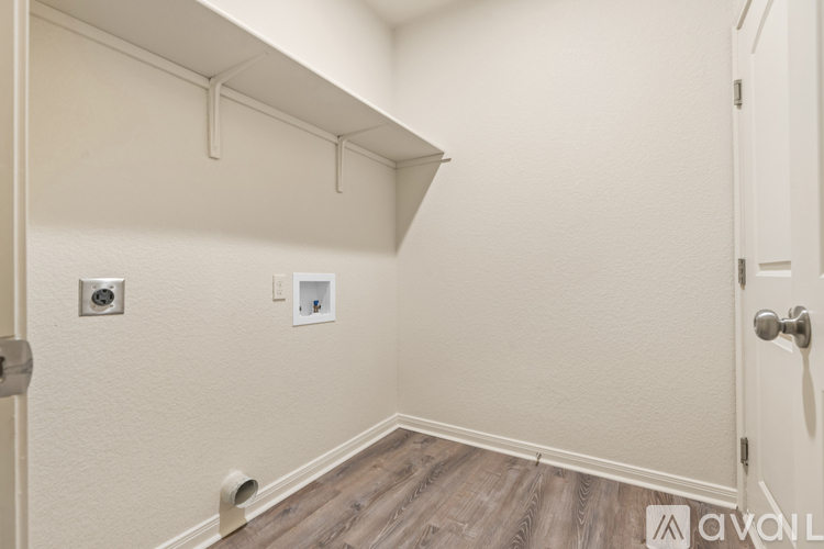 A kitchen area with a refrigerator, cabinets, and a countertop.