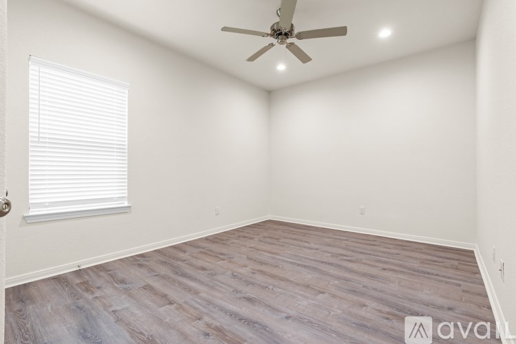 A kitchen with a granite countertop and white cabinets.