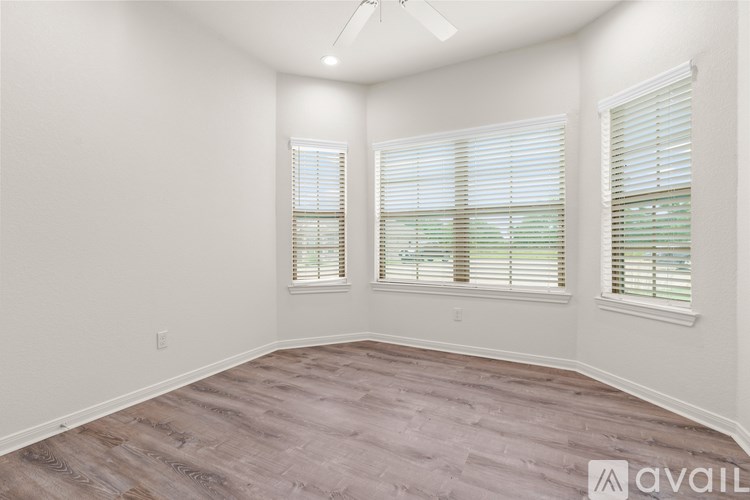 A hallway with a wooden floor and white walls.