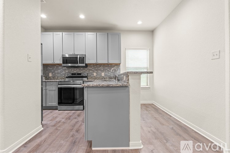 A room with a white door and a window with blinds.