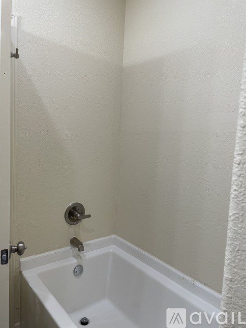A white bathroom with a tub and shower.