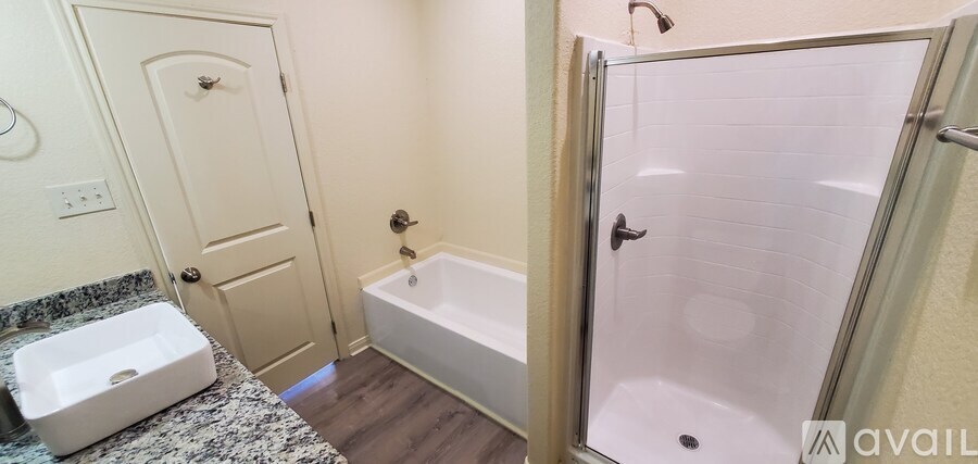 A bathroom with a tub, toilet and sink.