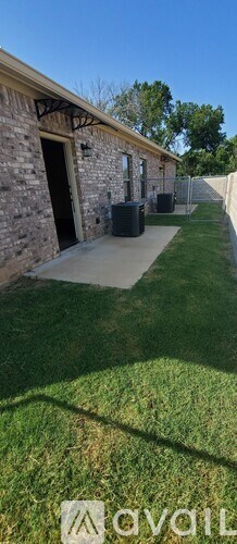 A stone building with a black door and a window.