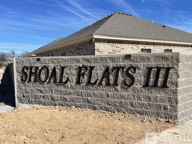 Shoal Flats II is a stone building with a brown roof.