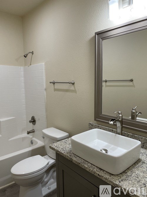 A white toilet sits next to a sink in a bathroom.