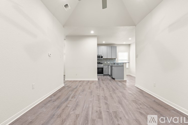 A room with a ceiling fan and two windows with blinds.