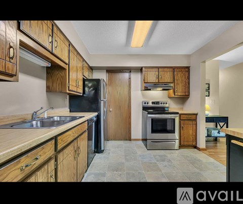 A kitchen with wooden cabinets and stainless steel appliances.