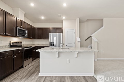 A kitchen with brown cabinets and a white island.