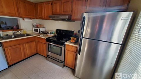 A kitchen with a stainless steel refrigerator and oven.