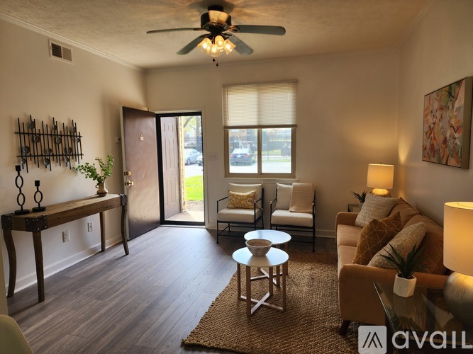 A living room with a ceiling fan and a couch.
