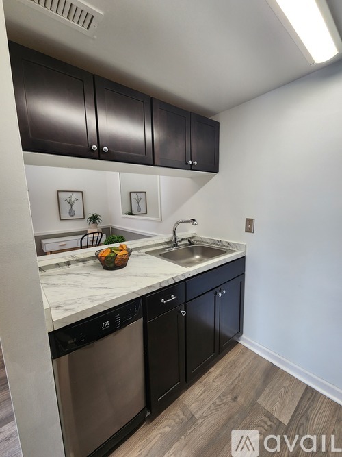 A kitchen with black cabinets and a white countertop.