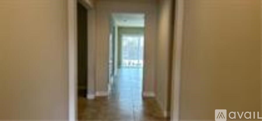 A long hallway with a door at the end.