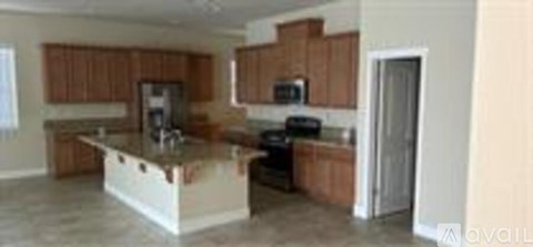A kitchen with brown cabinets and a white island.