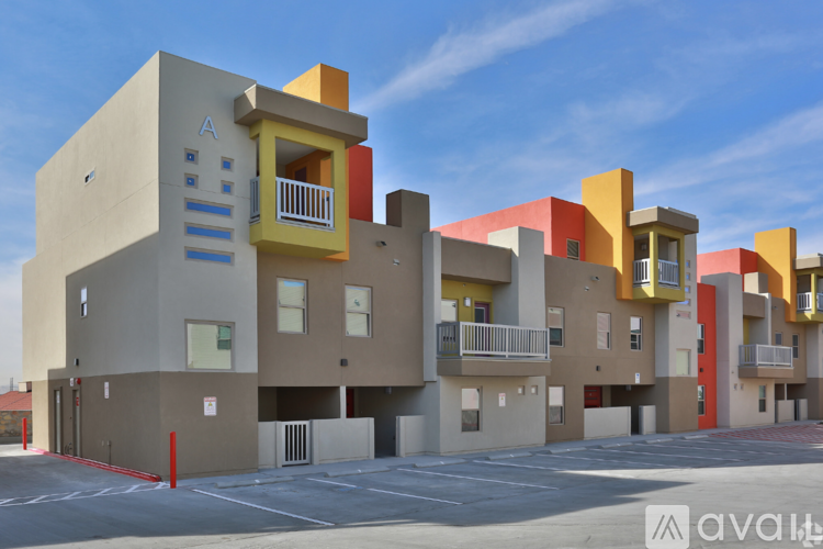 A modern apartment complex with balconies and multiple stories.