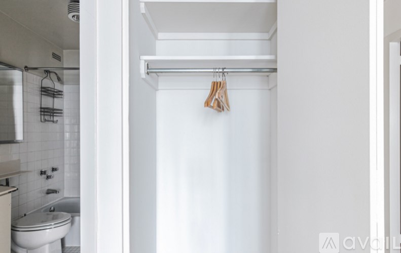 A white bathroom with a toilet and a shower.