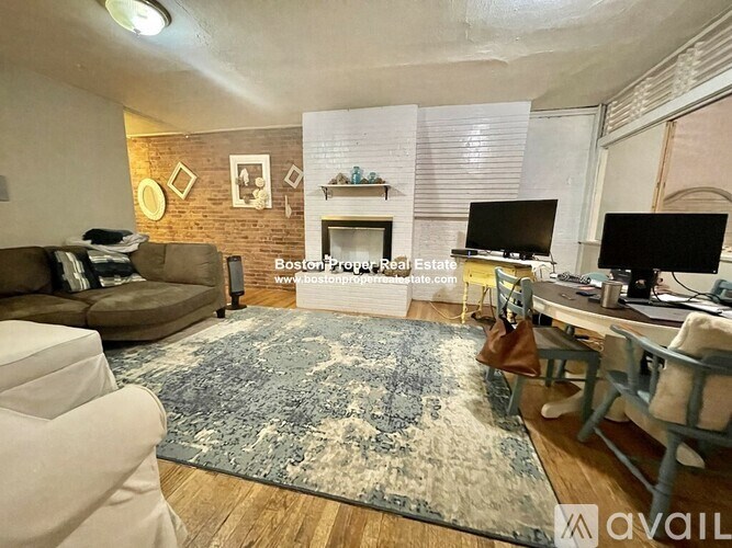 A living room with a fireplace and a television.
