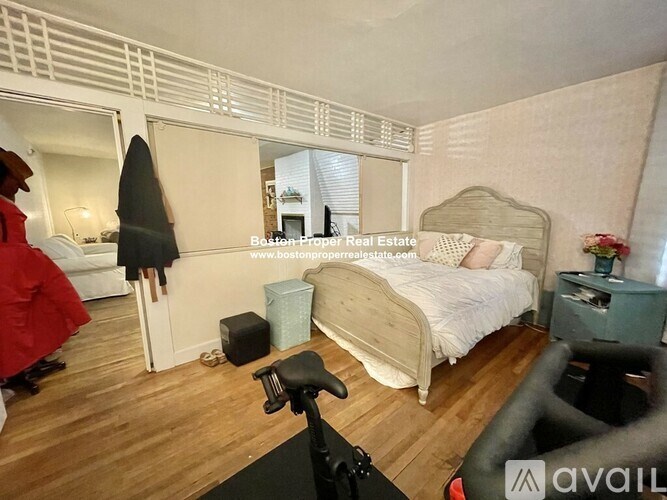 A bedroom with a bed, dresser, and mirror.