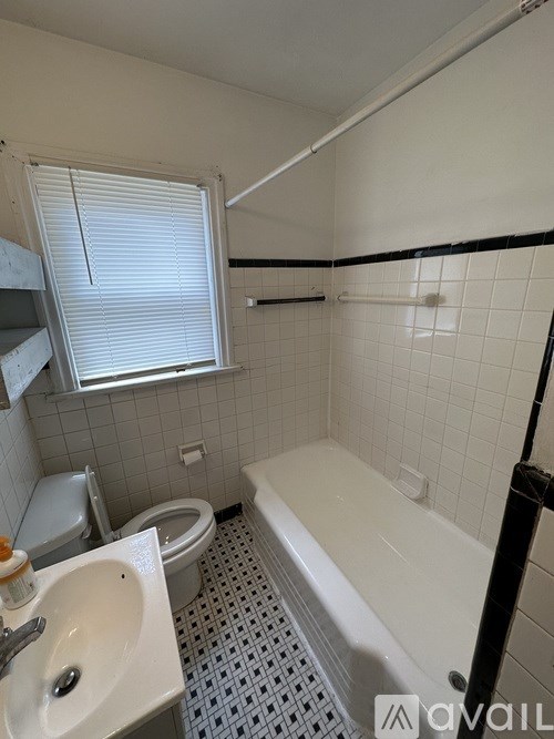 A bathroom with a white sink, toilet, and bathtub.