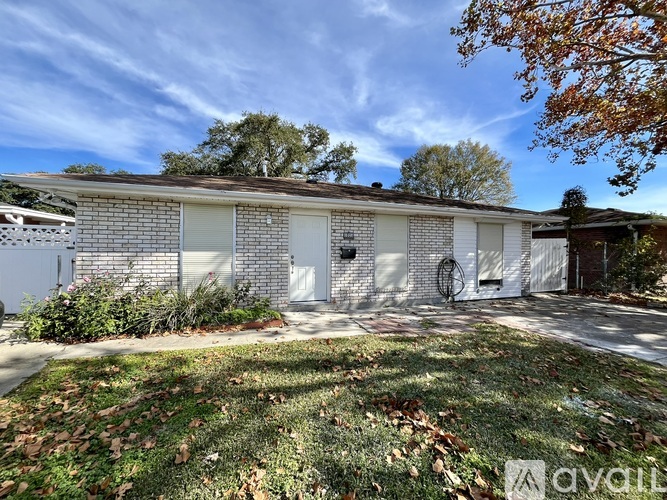 A two-story house with a garage and a driveway.