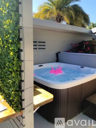A hot tub with a pink inflatable unicorn inside.