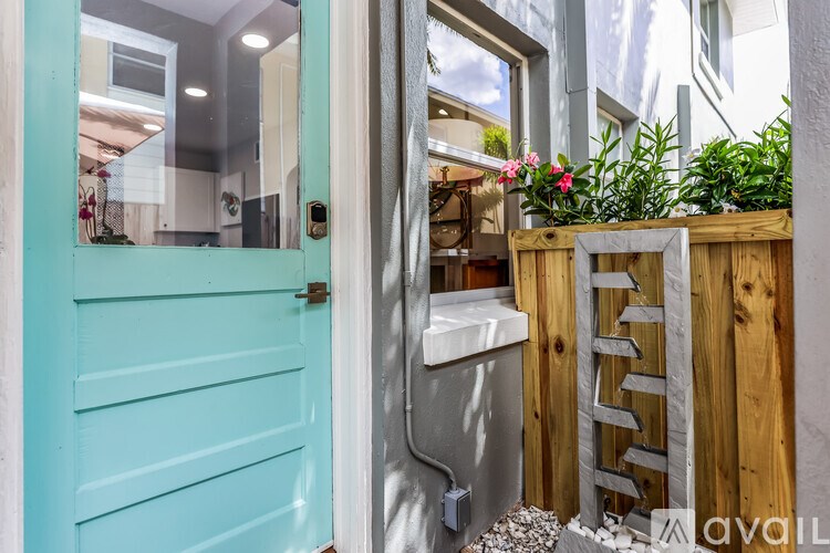 A blue door is open to a kitchen.