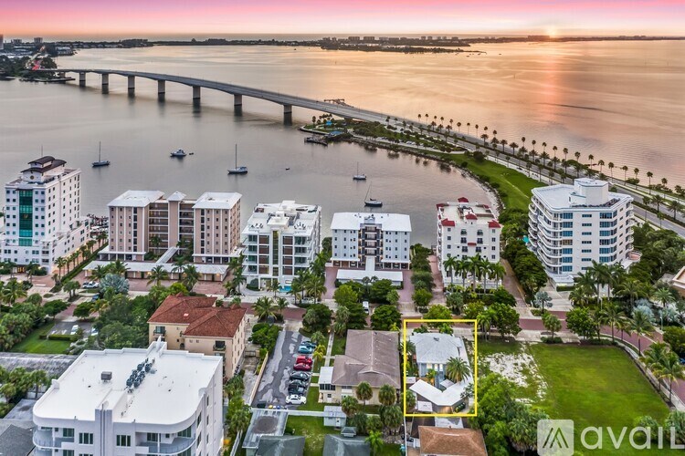 A sunset view of a city with a bridge and buildings.
