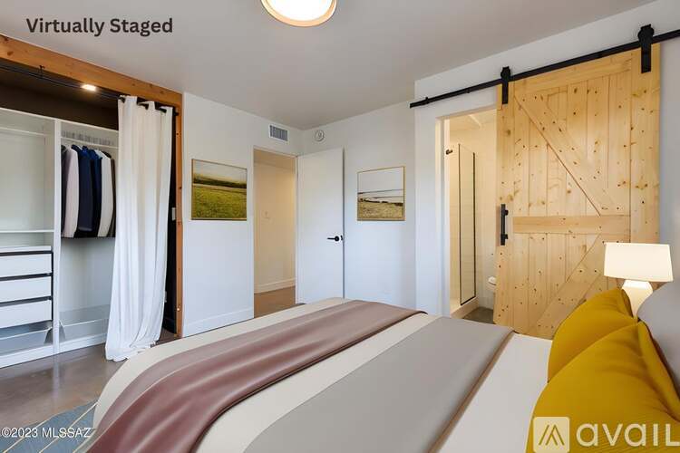 A bedroom with a bed, a wardrobe, and a wooden door.