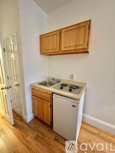 A kitchen with wooden cabinets and a white dishwasher.