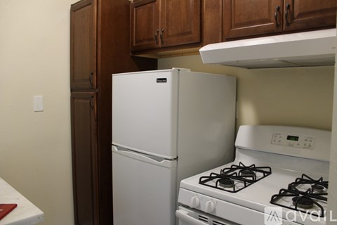 A white refrigerator and a white gas stove in a kitchen.