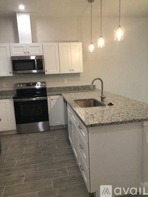 A kitchen with granite countertops and stainless steel appliances.