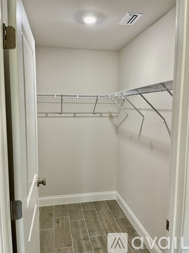 A white closet with a white door and a white wall.