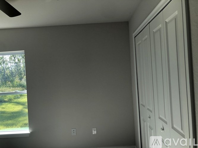 A room with a window and a white door.