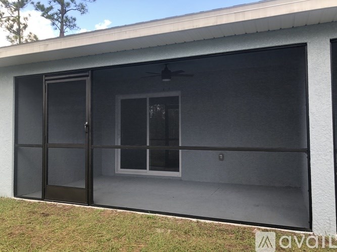 A modern house with a black door and window.