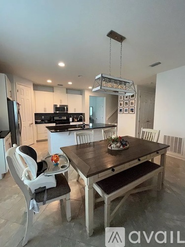A modern kitchen with a dining table and chairs.