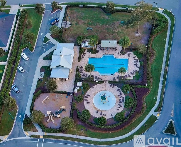 A bird's eye view of a property with a swimming pool and a fountain.