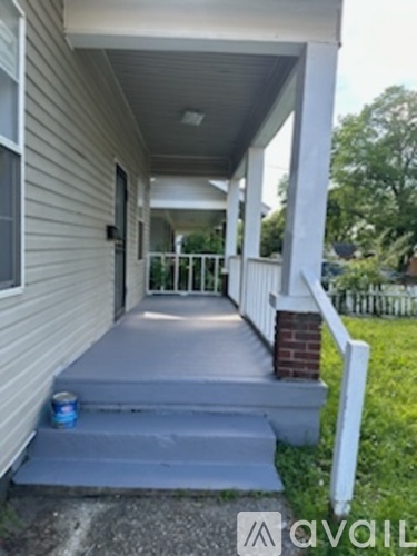 A white house with a grey front porch.