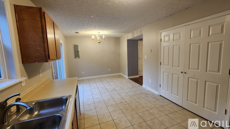 A kitchen with a sink and a door.