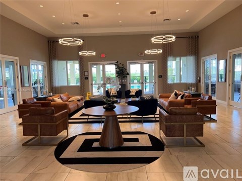 A spacious living room with a central coffee table and multiple seating options.