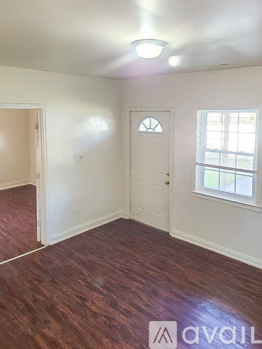 A room with a white door and a window.