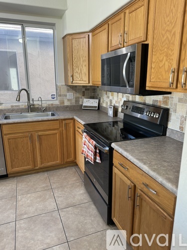 A kitchen with wooden cabinets and a black oven.