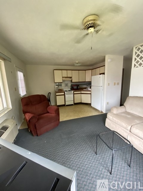 A living room with a red chair and a grey sofa.