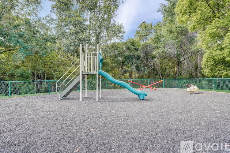 A playground with a green slide and a red slide.