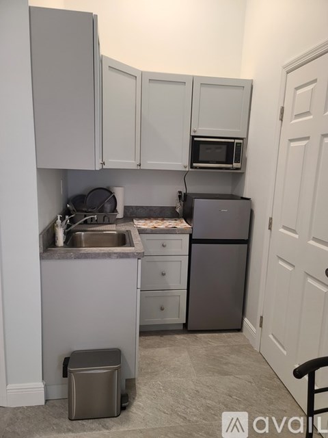 A kitchen with a sink, stove, and refrigerator.