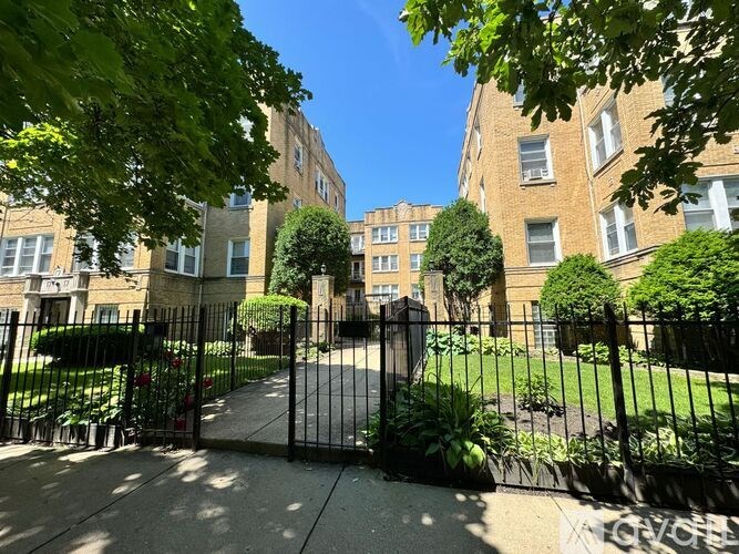 A black metal gate blocks the entrance to a sidewalk.